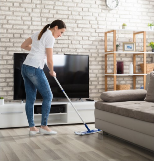 Lady sweeping hardwood floor | Fairmont Flooring