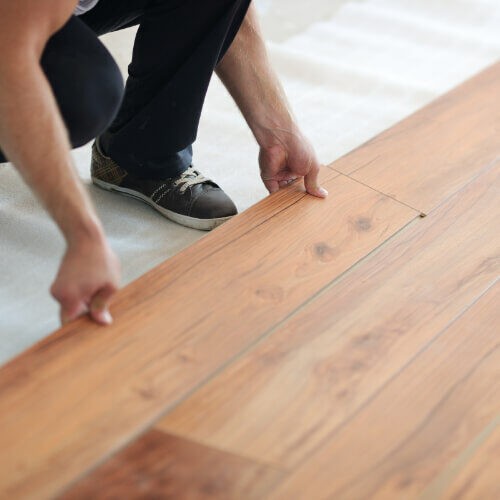 Man installing laminate flooring | Fairmont Flooring